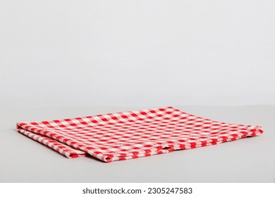 top view with red empty kitchen napkin isolated on table background. Folded cloth for mockup with copy space, Flat lay. Minimal style.