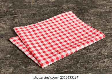 top view with red empty kitchen napkin isolated on table background. Folded cloth for mockup with copy space, Flat lay. Minimal style.