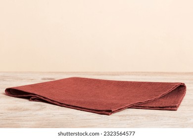 top view with red empty kitchen napkin isolated on table background. Folded cloth for mockup with copy space, Flat lay. Minimal style.