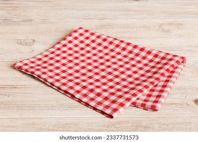 top view with red empty kitchen napkin isolated on table background. Folded cloth for mockup with copy space, Flat lay. Minimal style.