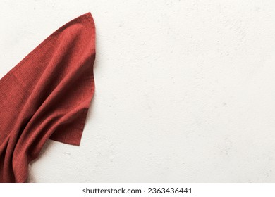 top view with red empty kitchen napkin isolated on table background. Folded cloth for mockup with copy space, Flat lay. Minimal style.