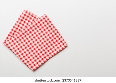 top view with red empty kitchen napkin isolated on table background. Folded cloth for mockup with copy space, Flat lay. Minimal style.