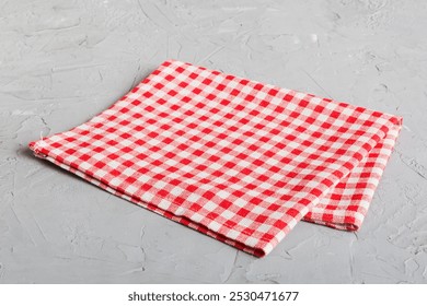top view with red empty kitchen napkin isolated on table background. Folded cloth for mockup with copy space, Flat lay. Minimal style.