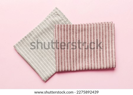 top view with red empty kitchen napkin isolated on table background. Folded cloth for mockup with copy space, Flat lay. Minimal style.