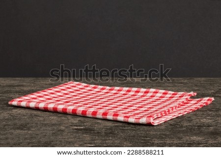 top view with red empty kitchen napkin isolated on table background. Folded cloth for mockup with copy space, Flat lay. Minimal style.