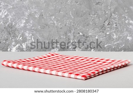 top view with red empty kitchen napkin isolated on table background. Folded cloth for mockup with copy space, Flat lay. Minimal style.