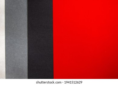 A top view of red, grey, and blac papers background and texture