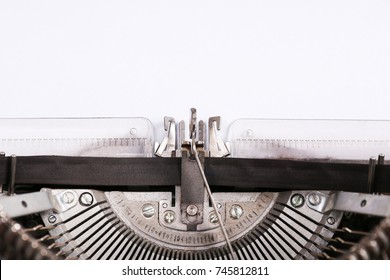 A top view of a red vintage typewriter maschine with a white blank sheet of paper.