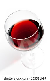 Top Of View Of Red Wine Glass Under Daily Light On White Table