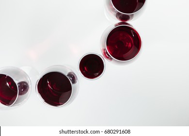 Top View Of Red Wine In Glasses Arranged Isolated On White