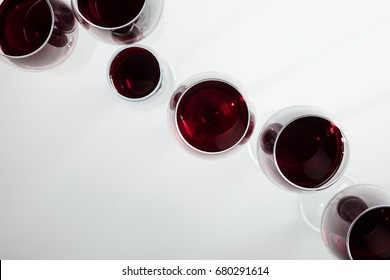 Top View Of Red Wine In Glasses Arranged Isolated On White