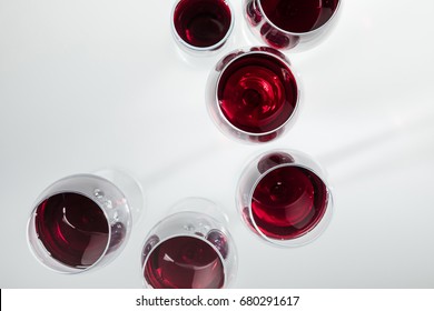 Top View Of Red Wine In Glasses Arranged Isolated On White