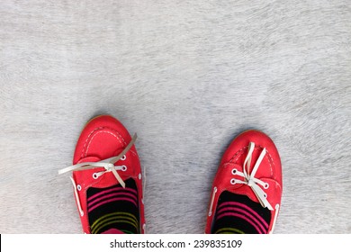  top view of red worn girl shoes over wooden textured background  - Powered by Shutterstock