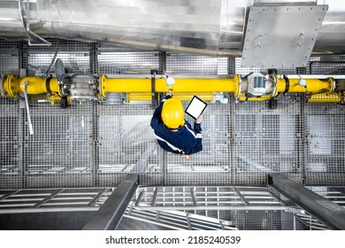 Top View Of Refinery Worker Checking Gas Pipeline Installations And Consumption In Petrochemical Factory.