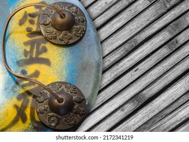 Top view of Reiki symbol with Tibetan bell and background with bamboo. (Translation: Reiki, vital energy)