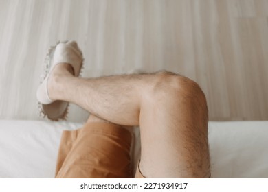 Top view of relax man sitting on sofa with crossing legs in cozy loft room. - Powered by Shutterstock