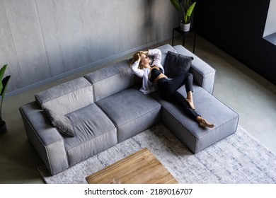 Top View Of Restful Woman While Lying On Couch With Head On Yellow Pillow After Work