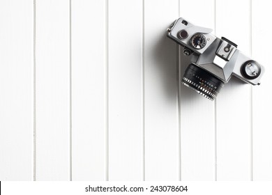 Top View Of Retro Camera On Wooden Table