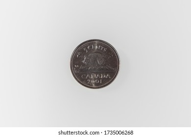 A Top View Of The Reverse Side Of A Canadian Nickel On A White Surface