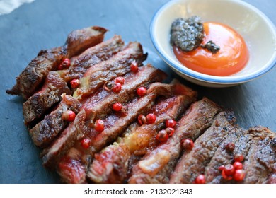 Top view of Rib-eye Pink Peppercorn Steak, Beef sliced ripe Medium Rare level. Foods concept. - Powered by Shutterstock