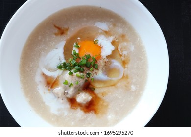 Top View Of Rice Porridge With Pork And Egg Or Congee Is Similar To Boil Rice But It Has Softer Texture Is On The Wooden Table For Breakfast In The Moring