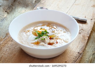 Top View Of Rice Porridge With Pork And Egg Or Congee Is Similar To Boil Rice But It Has Softer Texture Is On The Wooden Table For Breakfast In The Moring