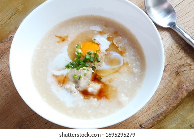 Top View Of Rice Porridge With Pork And Egg Or Congee Is Similar To Boil Rice But It Has Softer Texture Is On The Wooden Table For Breakfast In The Moring