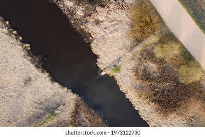 Top view of the river in the fields with the road