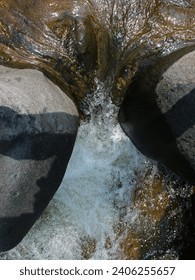 Top view of river flow between two rocks.