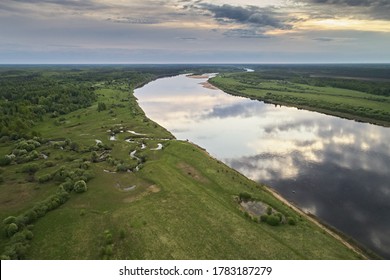 Top View Of The River, Green Fields And Forests In Spring. Abstract Landscape With A Village, Photography With Drone