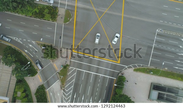 Top\
view of the road junctions. Crossroads in the city, cars drive\
aerial view. Aerial survey of highways of the road network.\
Machines moving at the intersection and\
denouement