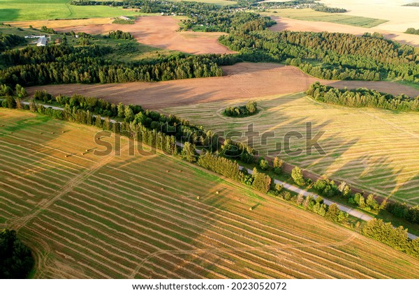 Top view of road near agricultural field. Road\
through the green plant. Ecosystem and environment concept at\
highway. Aerial view of countryside route. Ecological path\
background. Tourist way.
