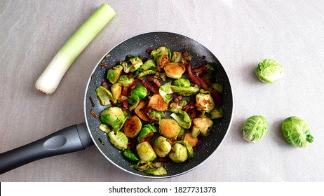 Top View Roasted Brussel Sprouts With Crispy Bacon And Leeks In A Pan