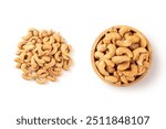 Top view of Roasted cashew nuts in wooden bowl with pile of cashew nuts on white background.