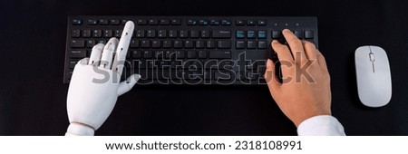 Top view robot and human hand typing keyboard. Artificial Intelligence or generative AI utilized in futuristic corporate work. Synthetic evolution to new era of technological advancement. Trailblazing