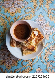 Top View Of Roti Canai Served With Bowl Of Curry