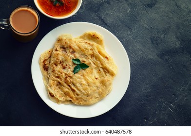 Top View Of Roti Canai, Tea And Curry With Space For Text