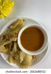 Top View Of Roti Parata Or Roti Canai With Dall Sauce On White Table.