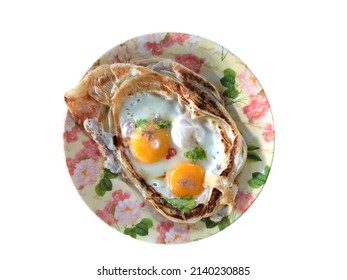 Top view of Roti Sarang Burung. It is pratha looks like bird nest with half cook eggs in the middle