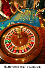 Top View Of Roulette With Players At The Table In A Casino.