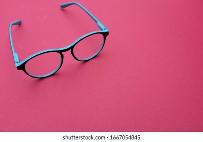 Top View Round Black Eye Glasses Pink Background