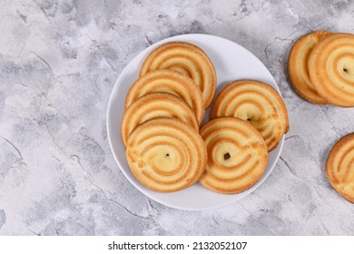 Top view of round ring shaped spritz biscuits, a type of German butter cookies made by extruding dough with a press fitted with patterned holes - Shutterstock ID 2132052107