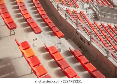 Top view: rows of red plastic chairs and concrete steps in sport stadium  - Powered by Shutterstock