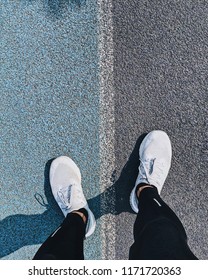 Top View Of Running Shoes On Track. Running Track