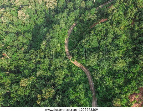 Top View\
of Rural Road, Path through the green forest and countryside of\
Thailand, Top view aerial photo from\
drone.