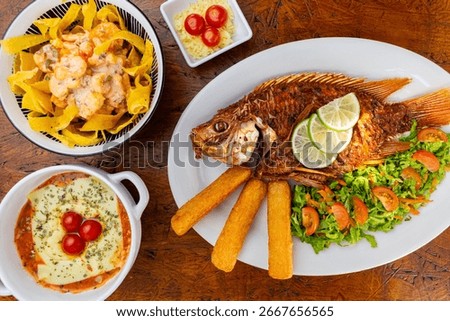 Top view of a rustic restaurant table with a variety of gourmet Colombian fusion dishes in direct sunlight, creating a warm and hearty feast.