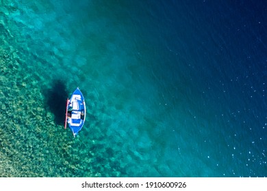 Top view of sail boat in Mediterranean sea clear blue water with copy space tropical summer background