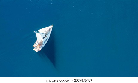 Top view of sailing luxury yacht at opened sea at sunny day in Croatia, view from drone