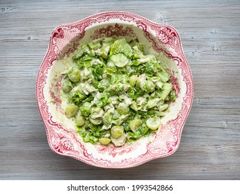 Top View Of Salad With Grapes, Tarragon And Chicken In Ornamental Bowl On Gray Wooden Table