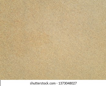 Top View Of Sandy Beach. Background With Copy Space And Visible Sand Texture. Detail Of Surface Texture With Small Pebble Rock On Dirty Ground And Surface For Background, Top View.